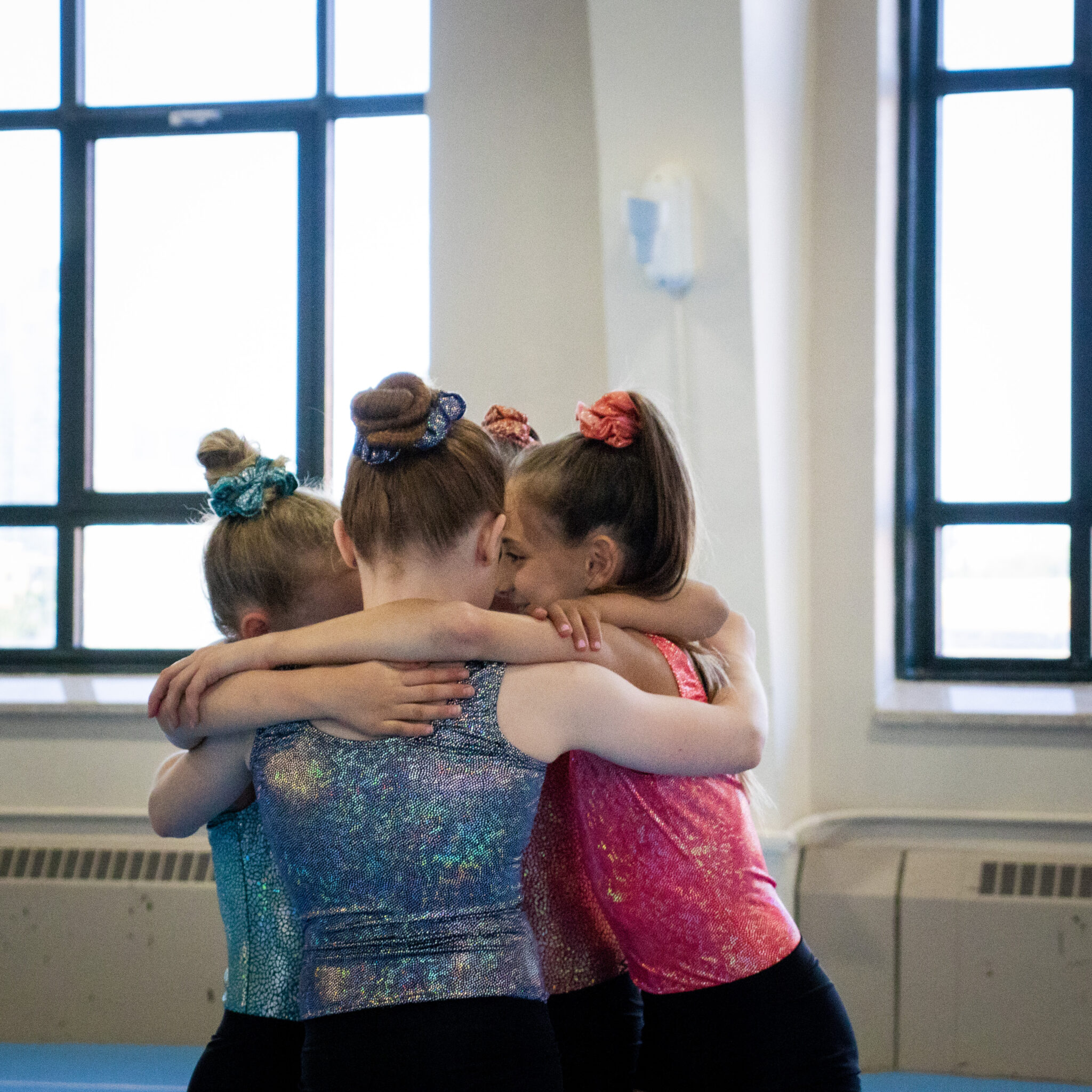 image of gymnasts having a group hug